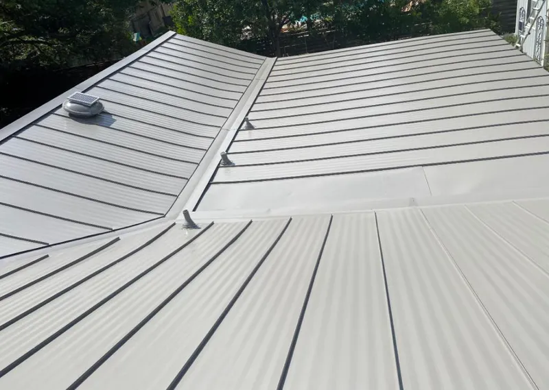 Solar attic fan installed on a metal roof for Roof Ventilation in Welcome
